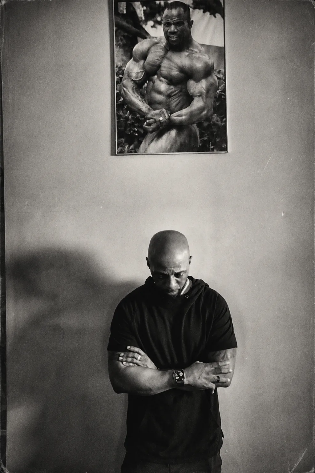 Jonathan Turmon standing beneath a portrait of his father, IFBB Pro George Turmon